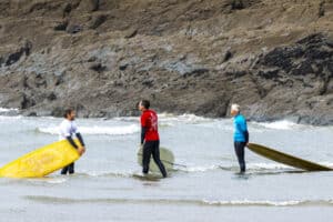 Surfers wait on the shore for their heat in the british longboard union classic comp at saunton.